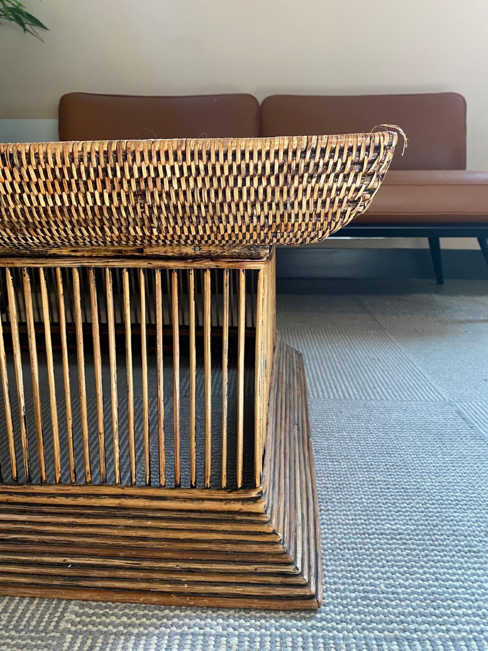 A rectangular warm brown wooden coffee table featuring a recessed top panel surrounded by woven rattan borders and vertical reed slatted sides. View VI