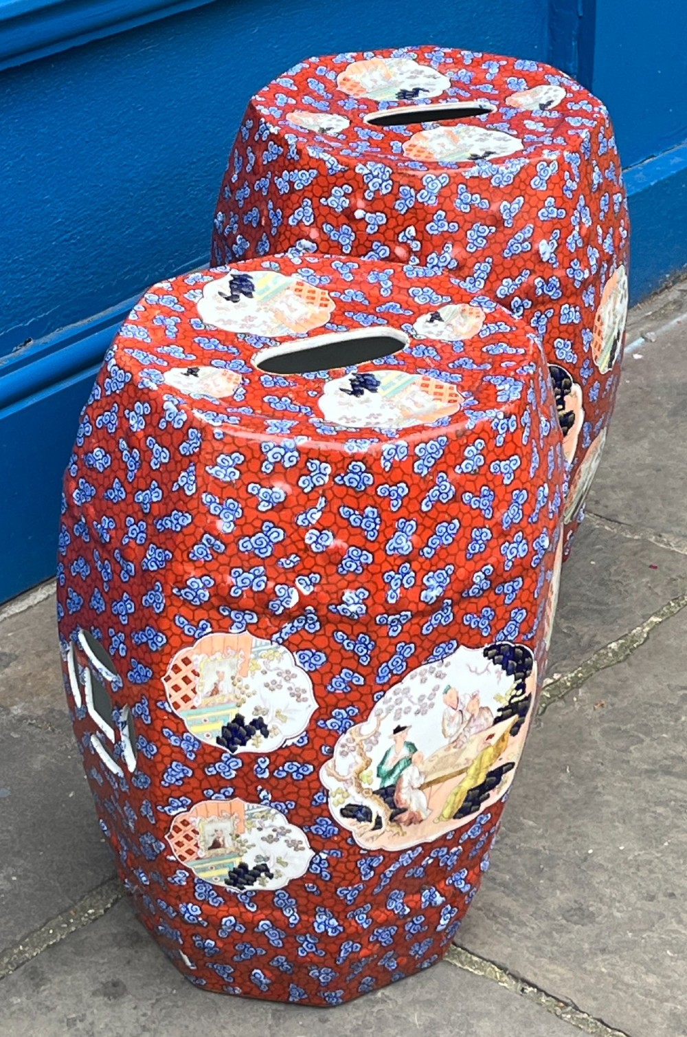 A pair of barrel-shaped clobbered ironstone garden seats decorated with a vibrant red and blue cloud pattern surrounding pictorial panels. View III
