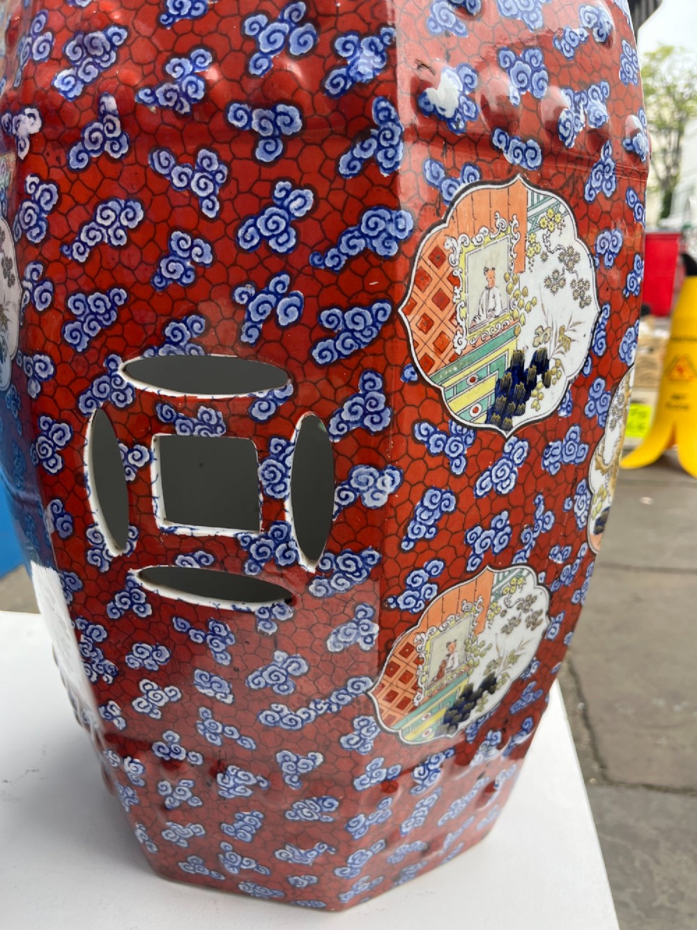 A pair of barrel-shaped clobbered ironstone garden seats decorated with a vibrant red and blue cloud pattern surrounding pictorial panels. View V