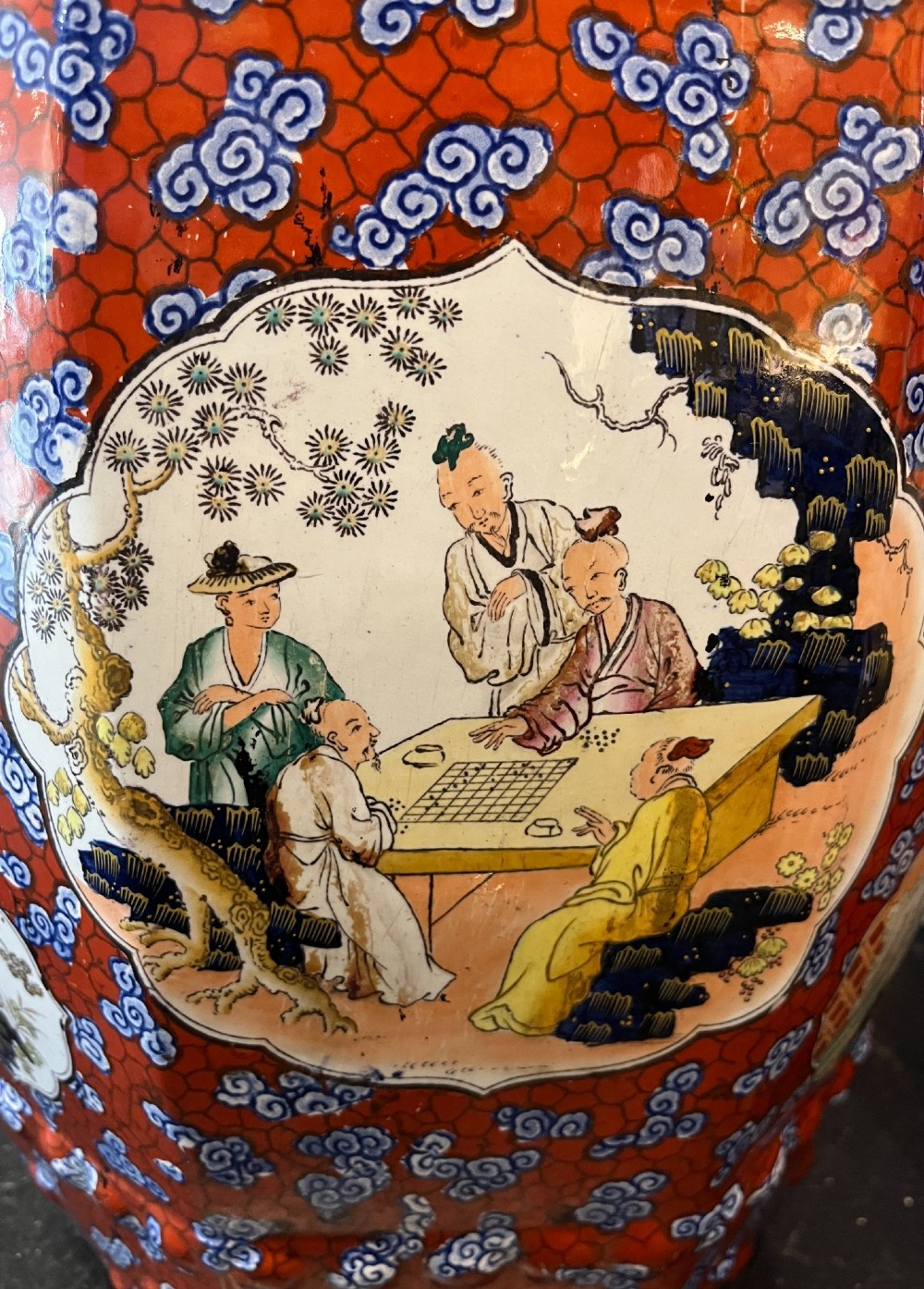 A pair of barrel-shaped clobbered ironstone garden seats decorated with a vibrant red and blue cloud pattern surrounding pictorial panels. View VI