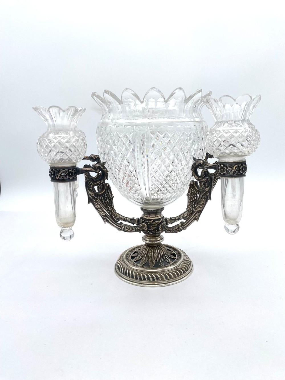 A Victorian cut glass epergne featuring a central diamond-cut bowl surrounded by four smaller glass holders set into silver-plated arms on a round base. View II