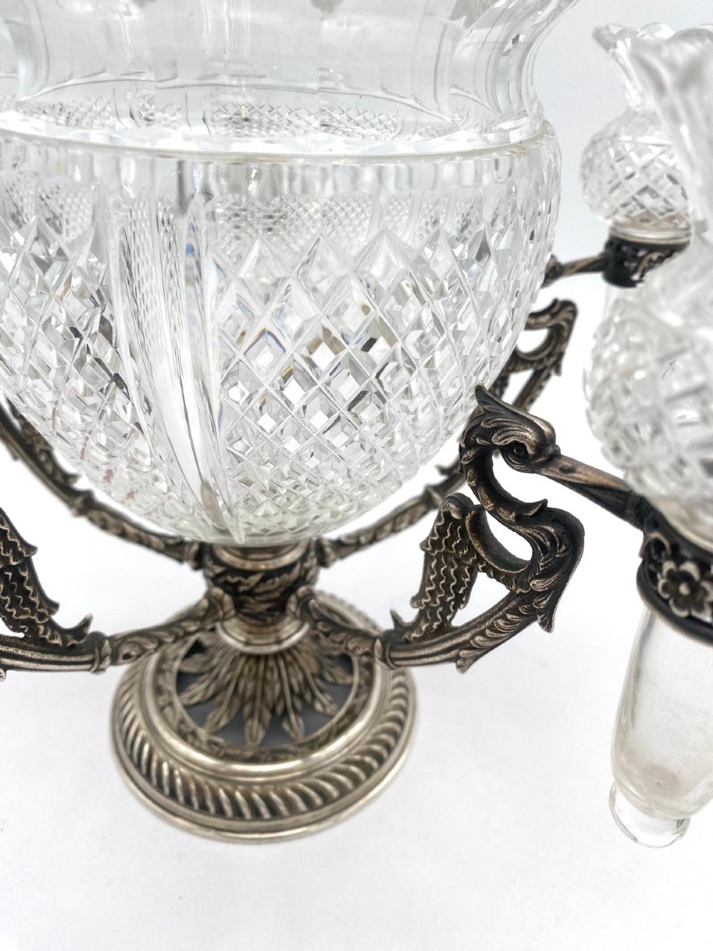 A Victorian cut glass epergne featuring a central diamond-cut bowl surrounded by four smaller glass holders set into silver-plated arms on a round base. View III
