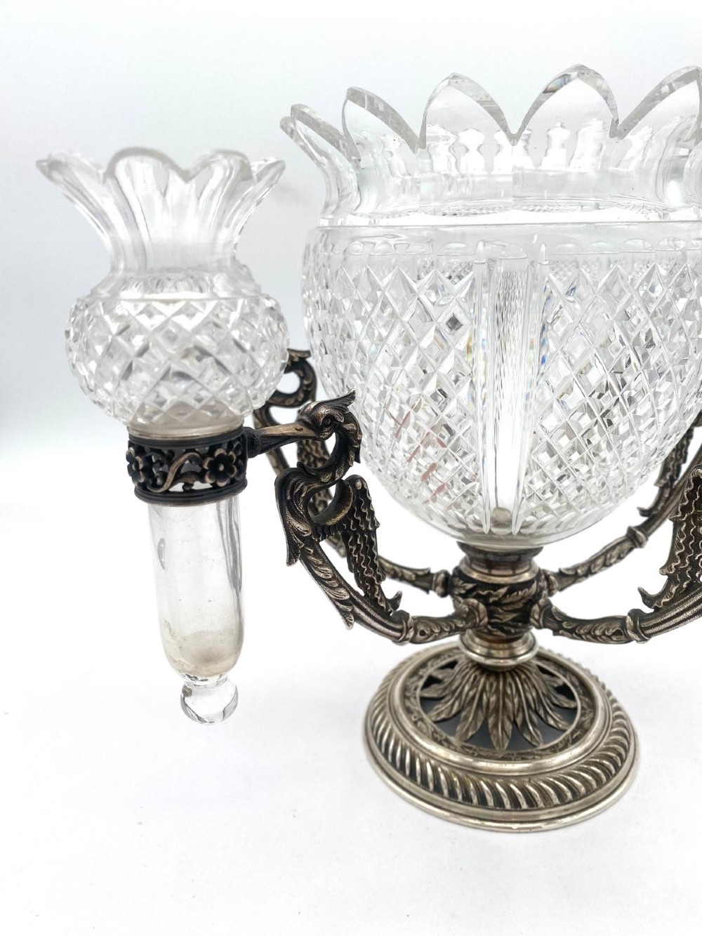 A Victorian cut glass epergne featuring a central diamond-cut bowl surrounded by four smaller glass holders set into silver-plated arms on a round base. View IV