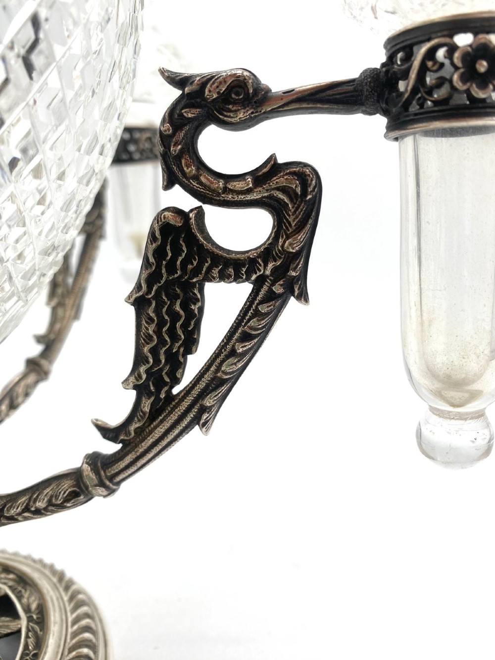 A Victorian cut glass epergne featuring a central diamond-cut bowl surrounded by four smaller glass holders set into silver-plated arms on a round base. View VIII