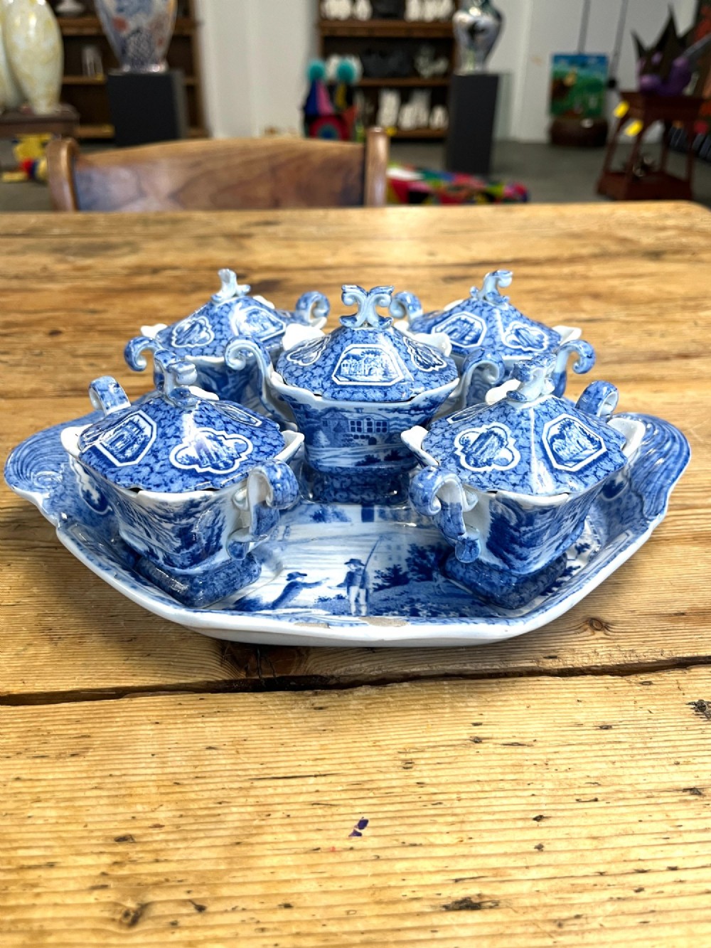 A nineteenth-century blue and white English transferware custard set featuring lidded pots arranged on a matching shaped tray.