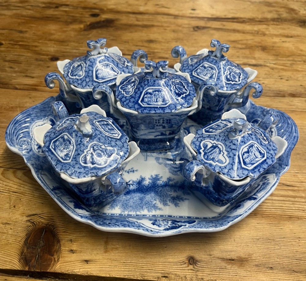 A nineteenth-century blue and white English transferware custard set featuring lidded pots arranged on a matching shaped tray. View III