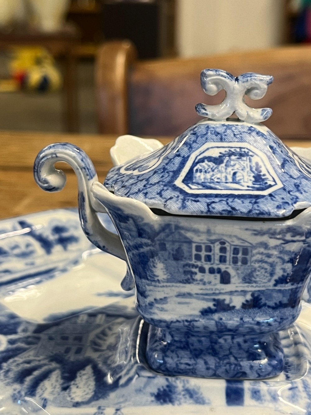 A nineteenth-century blue and white English transferware custard set featuring lidded pots arranged on a matching shaped tray. View IX