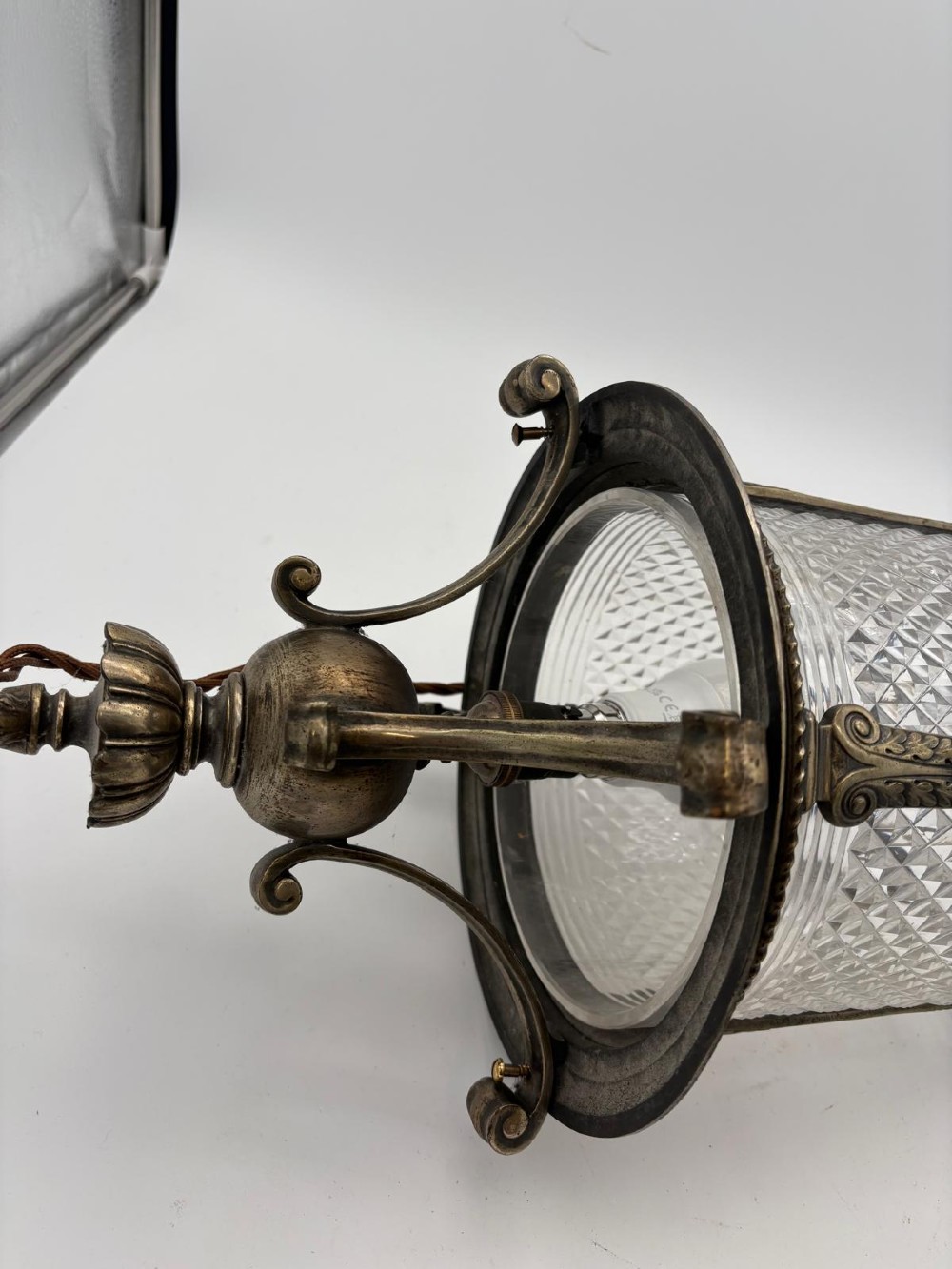 A late 19th-century cylindrical lantern featuring diamond-cut glass panels enclosed in a silvered bronze frame with classical pilasters and finials. View VIII