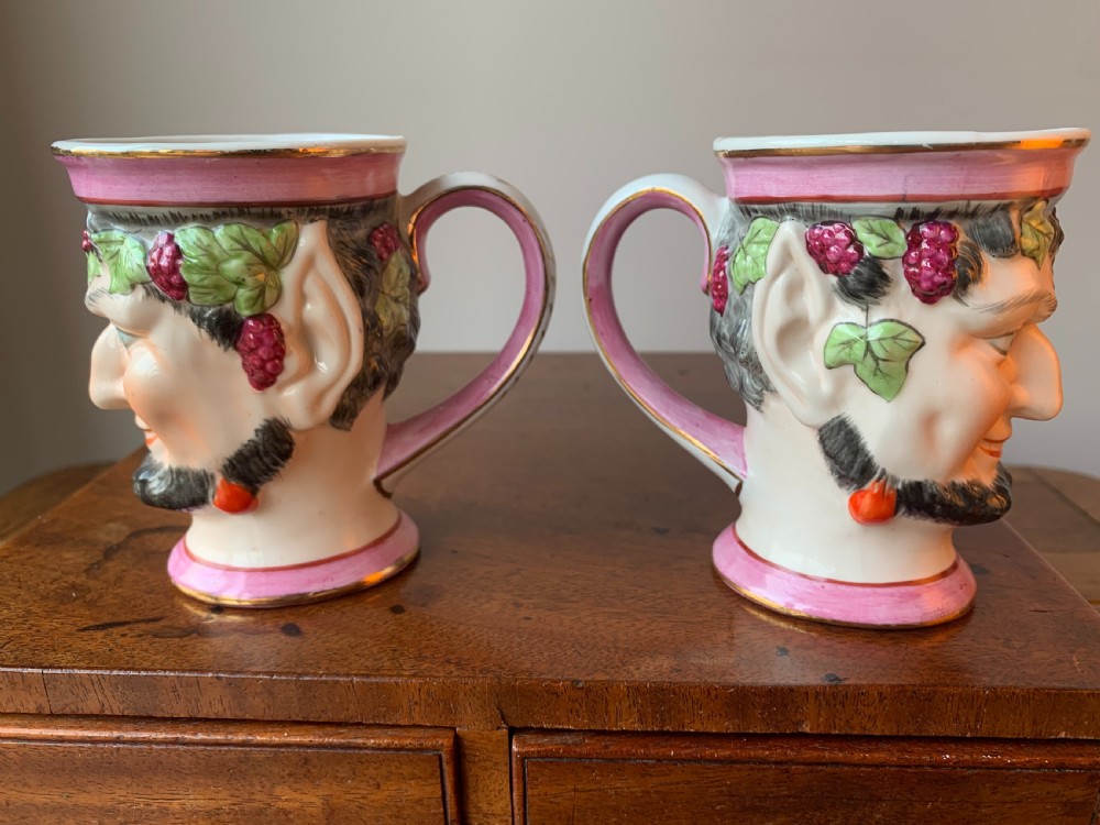 A set of four Victorian Staffordshire ceramic wine cups moulded in the form of bearded satyr faces with grapevine crowns and pink gilded rims. View VII