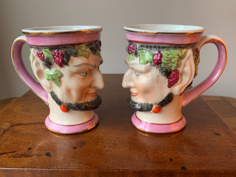 A set of four Victorian Staffordshire ceramic wine cups moulded in the form of bearded satyr faces with grapevine crowns and pink gilded rims. View IX