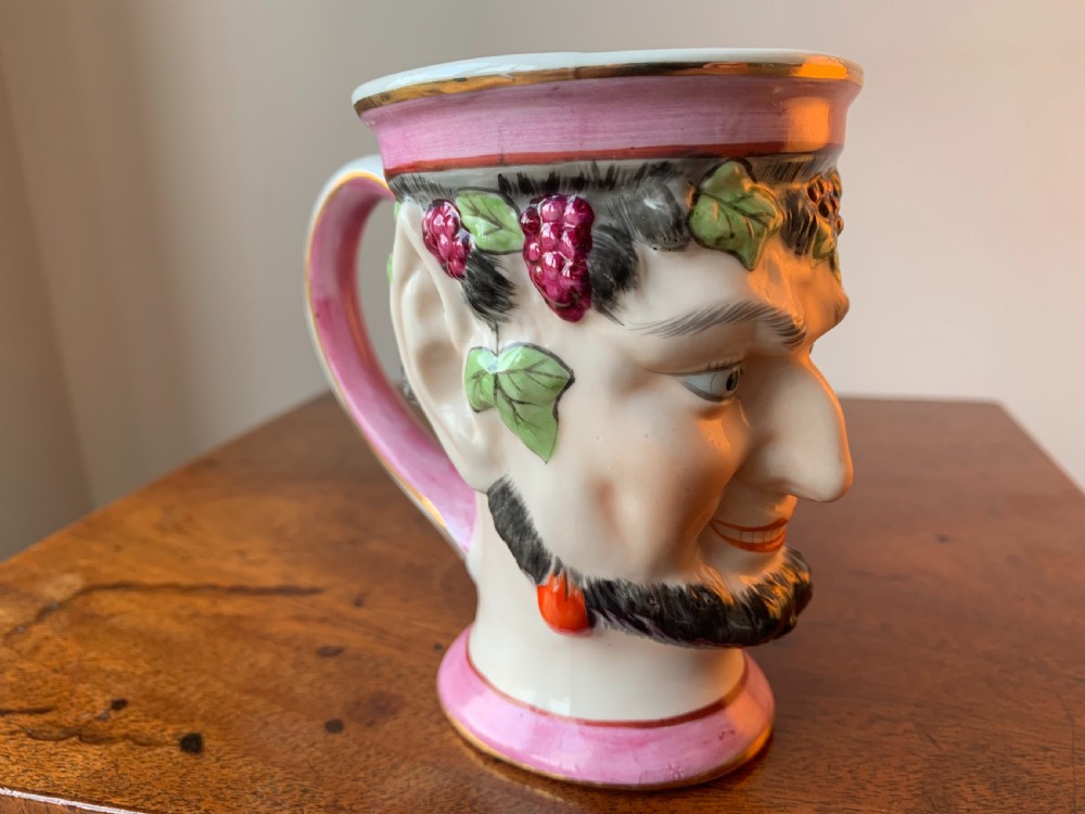 A set of four Victorian Staffordshire ceramic wine cups moulded in the form of bearded satyr faces with grapevine crowns and pink gilded rims. View XIII