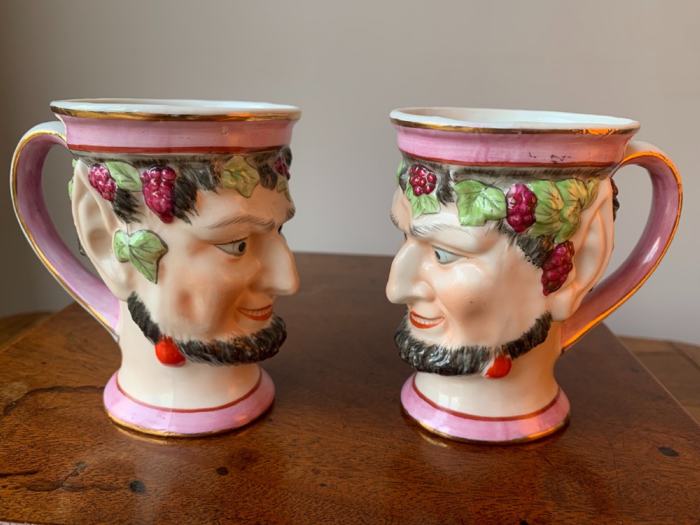 A set of four Victorian Staffordshire ceramic wine cups moulded in the form of bearded satyr faces with grapevine crowns and pink gilded rims. View XIX