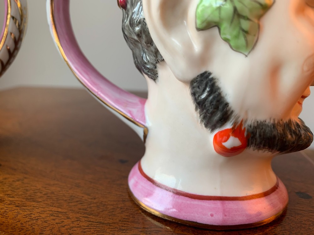 A set of four Victorian Staffordshire ceramic wine cups moulded in the form of bearded satyr faces with grapevine crowns and pink gilded rims. View XXII