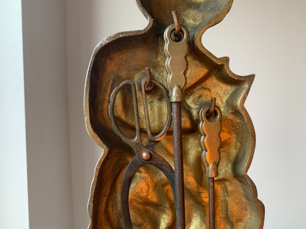 A gilded brass Art Deco sculptural companion set piece depicting a child holding a lamb atop a stepped geometric base. View IV