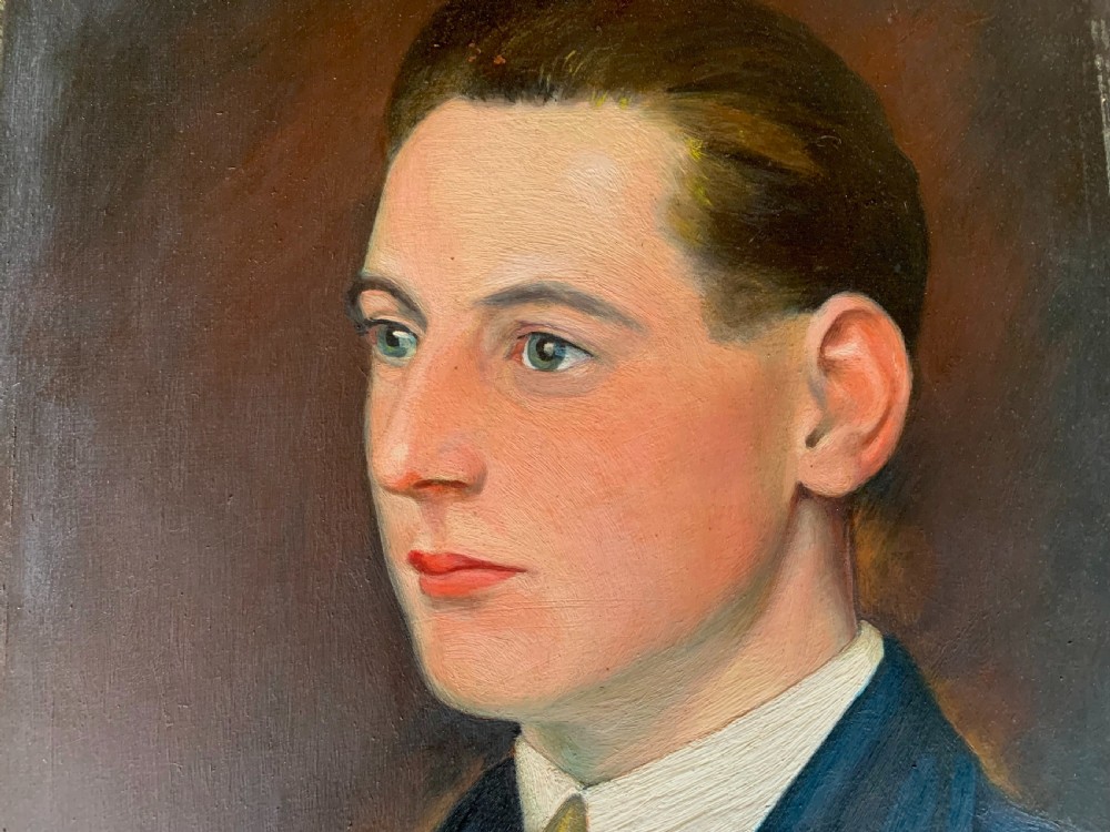 An unsigned Edwardian oil portrait on board depicting a young man in a blue jacket and striped tie, framed within an ornate carved giltwood frame. View IV