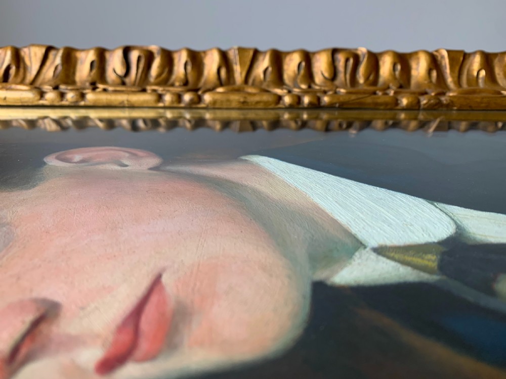 An unsigned Edwardian oil portrait on board depicting a young man in a blue jacket and striped tie, framed within an ornate carved giltwood frame. View XI