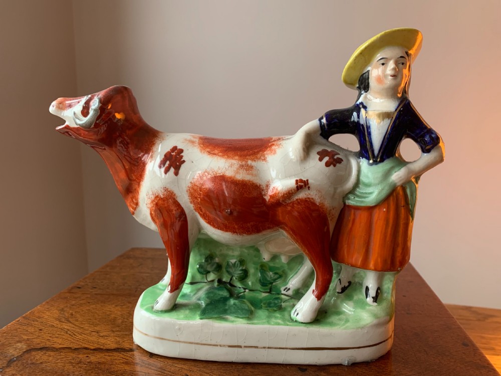 ANTIQUE STAFFORDSHIRE POTTERY COW AND MILKMAID FIGURE / CREAMER JUG, 19TH CENTURY