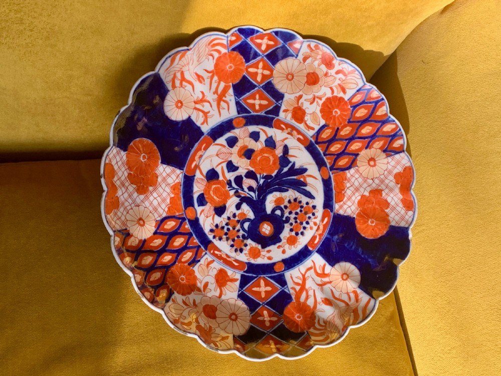 A nineteenth-century Japanese Imari porcelain charger featuring a scalloped rim, hand-painted in cobalt blue and iron-red floral and geometric brocade panels. View XVII