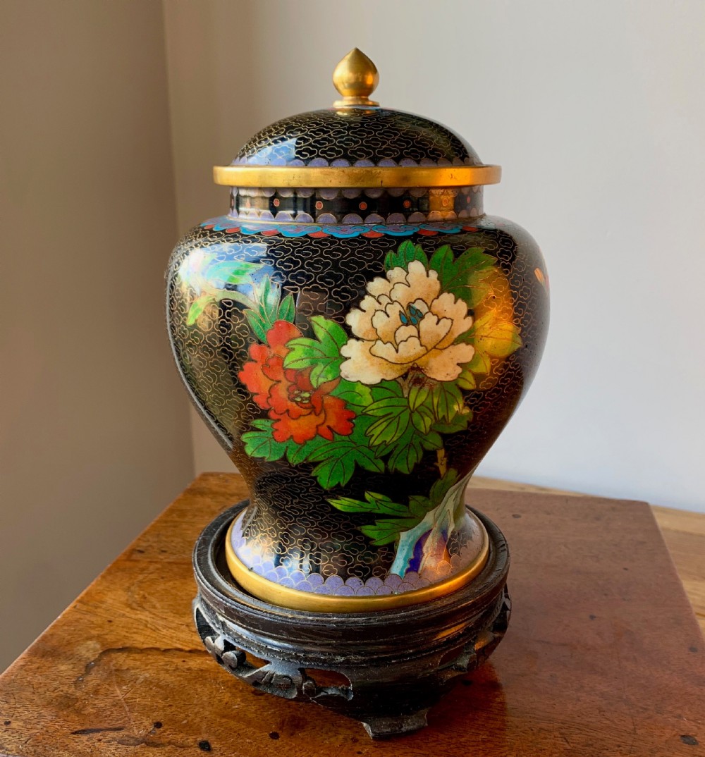 CHINESE CLOISONNE LIDDED VASE ON CARVED WOODEN LACQUERED STAND.