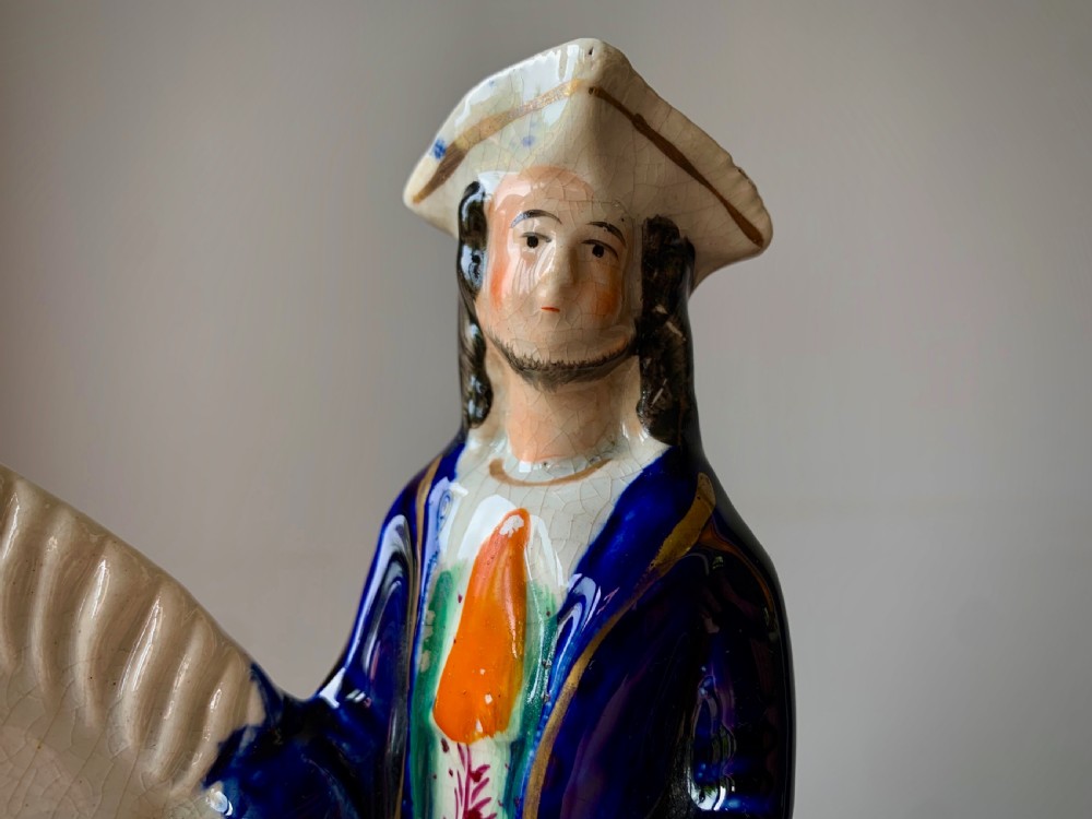 A Victorian Staffordshire pottery flatback figure depicting the highwayman Tom King on horseback wearing a tricorn hat and blue coat. View III