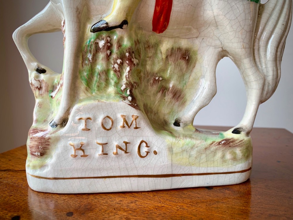 A Victorian Staffordshire pottery flatback figure depicting the highwayman Tom King on horseback wearing a tricorn hat and blue coat. View VII