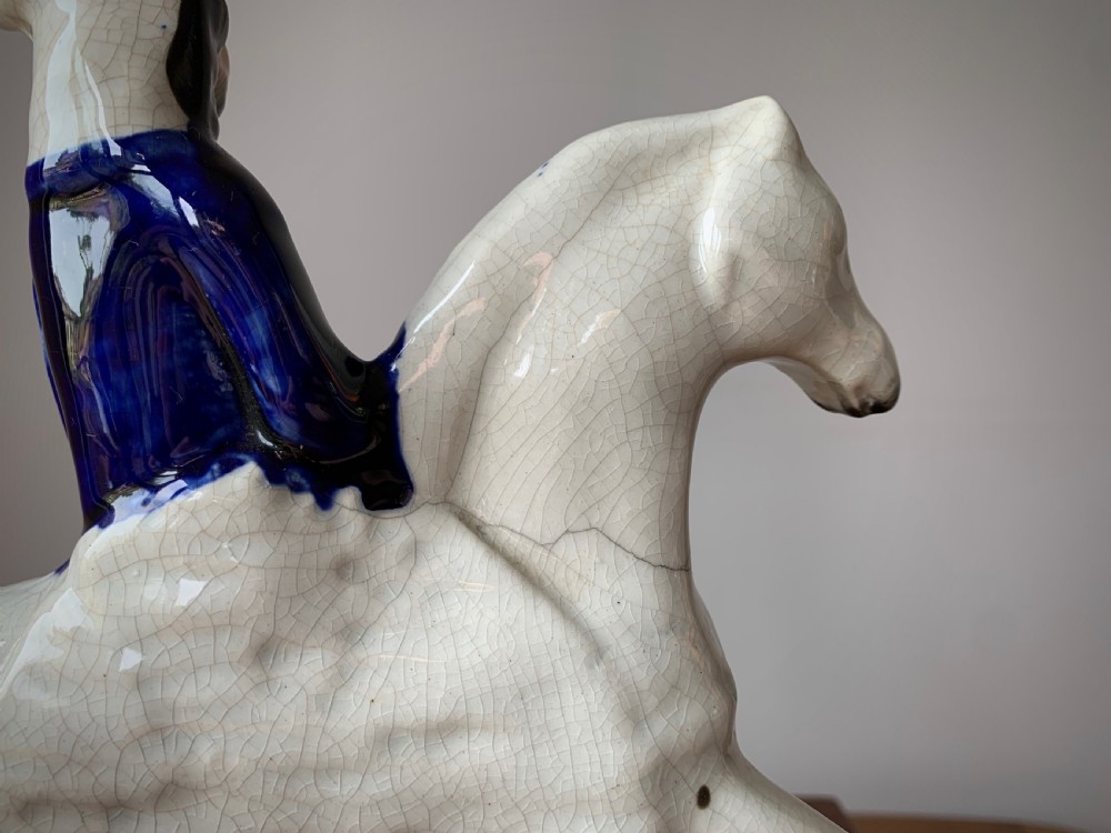 A Victorian Staffordshire pottery flatback figure depicting the highwayman Tom King on horseback wearing a tricorn hat and blue coat. View XI