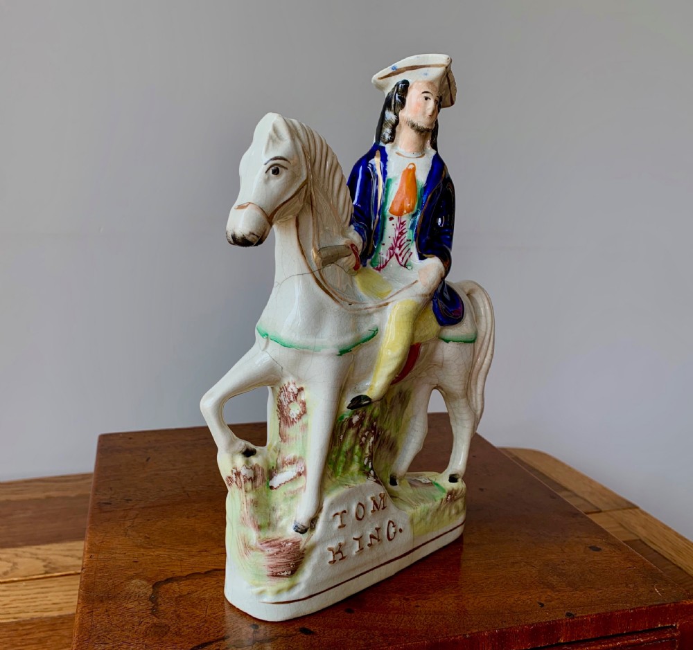 A Victorian Staffordshire pottery flatback figure depicting the highwayman Tom King on horseback wearing a tricorn hat and blue coat. View XIII