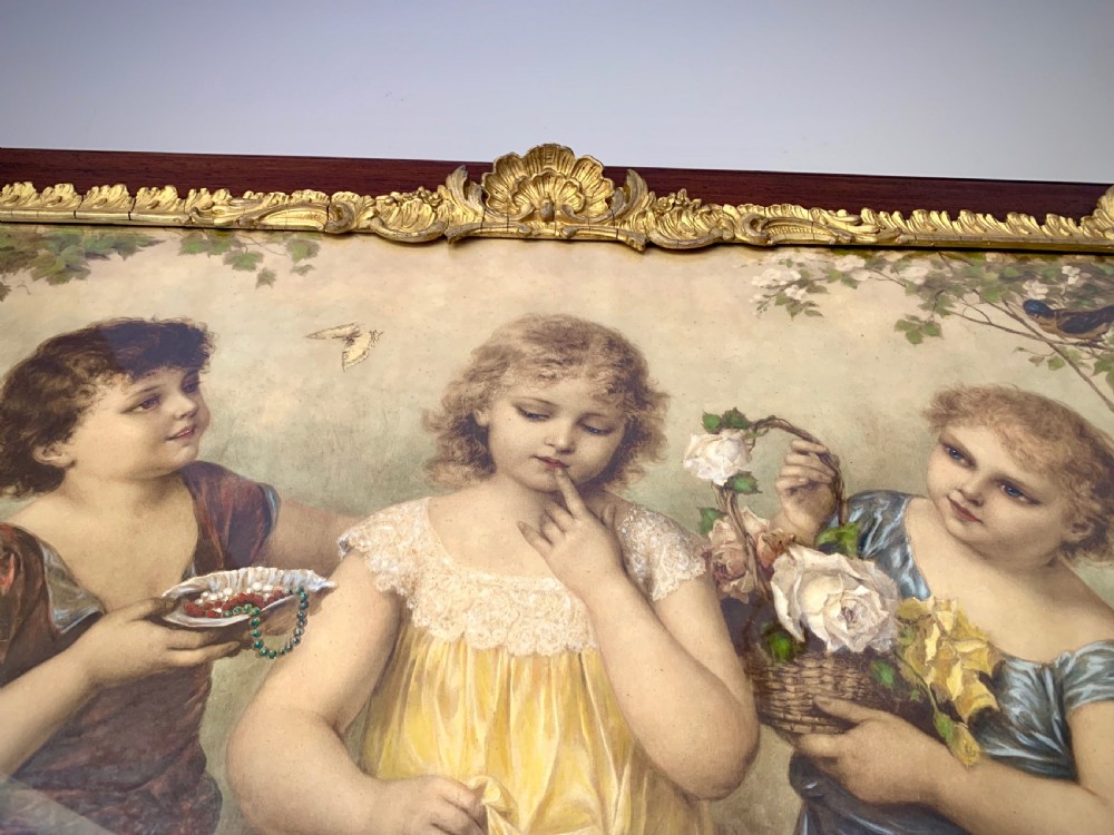 A horizontal Victorian print depicting three children in a garden setting, enclosed in a gilded Rococo-style inner frame set within a polished mahogany outer border. View V