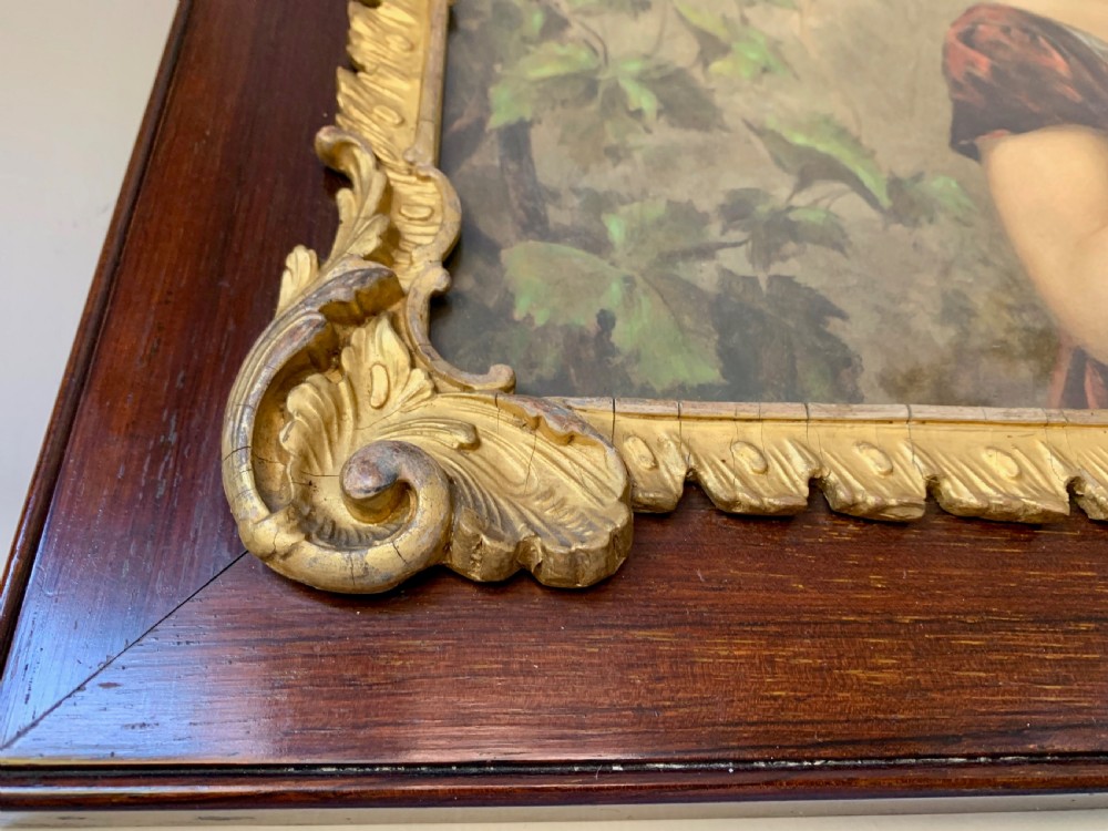 A horizontal Victorian print depicting three children in a garden setting, enclosed in a gilded Rococo-style inner frame set within a polished mahogany outer border. View IX