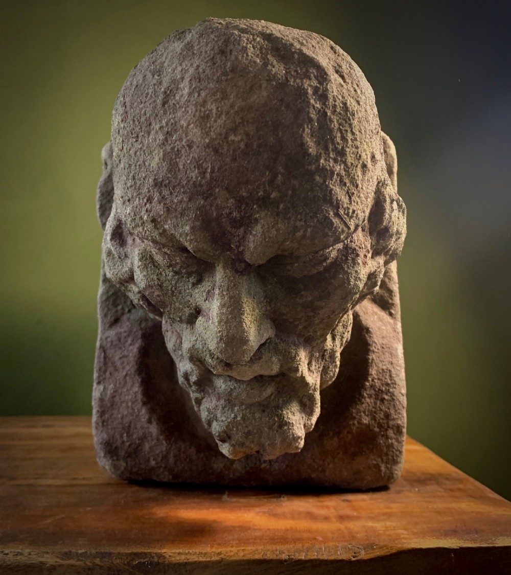 CARVED STONE HEAD OF BEARDED MAN