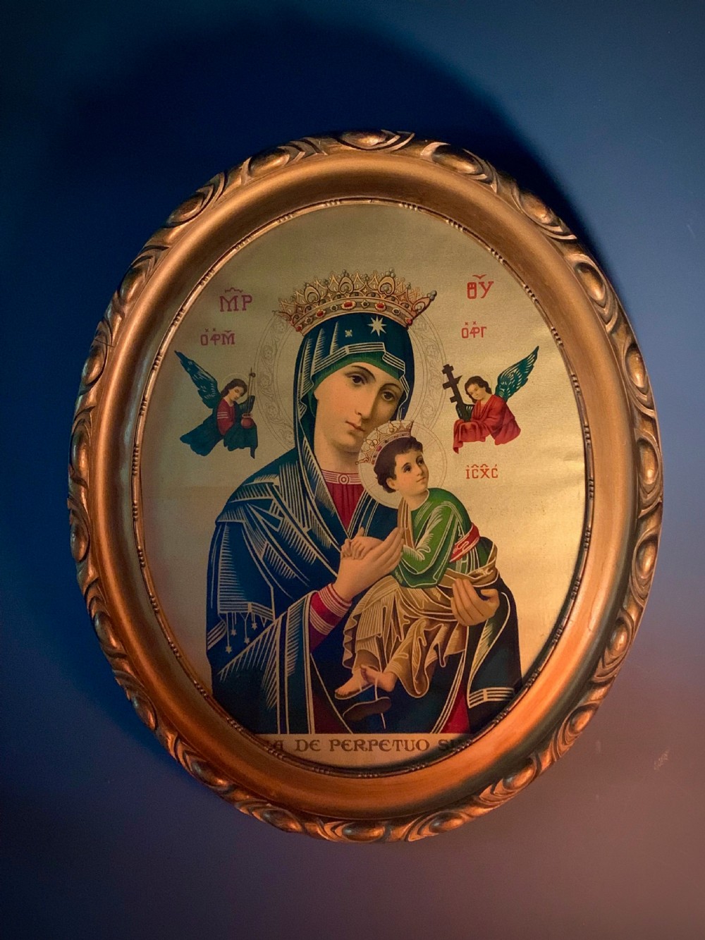 An oval gilt-framed Victorian print depicting the Virgin Mary holding the Christ Child flanked by angels in Byzantine iconographic style. View V