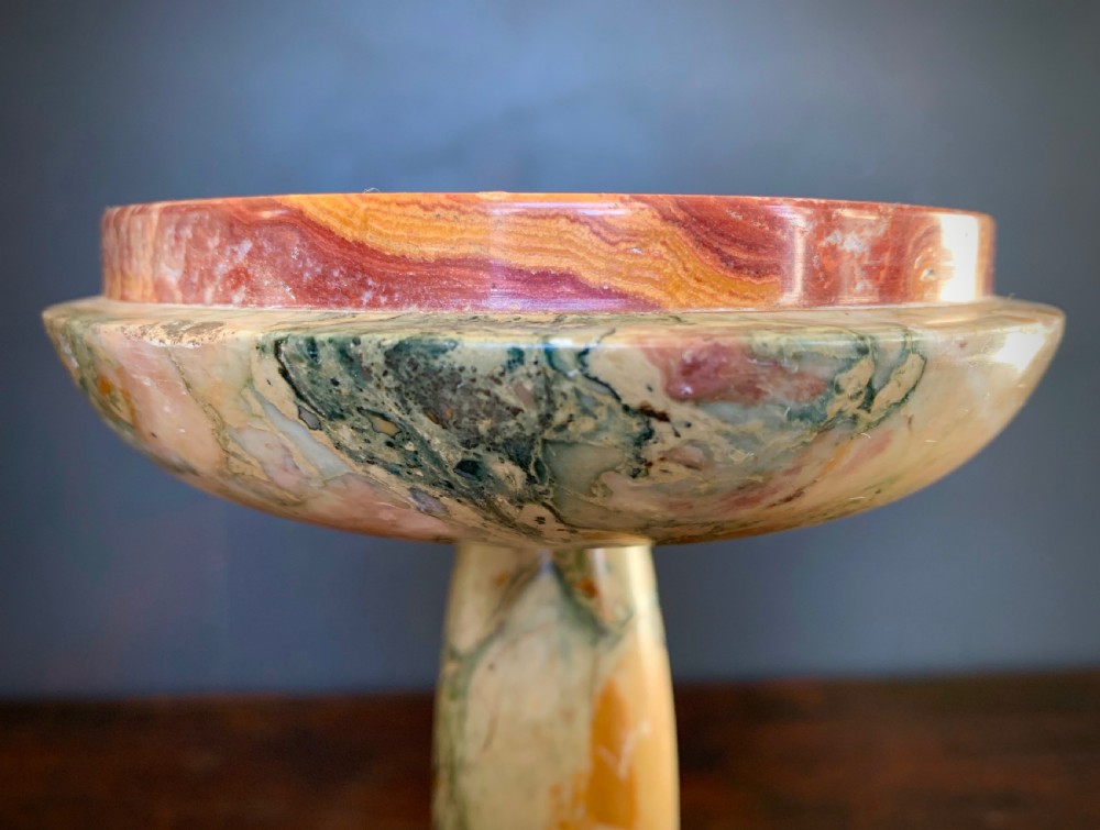 A pair of turned, variegated marble tazzas featuring shallow circular dishes raised on baluster stems and round bases in shades of red, green, and tan. View III