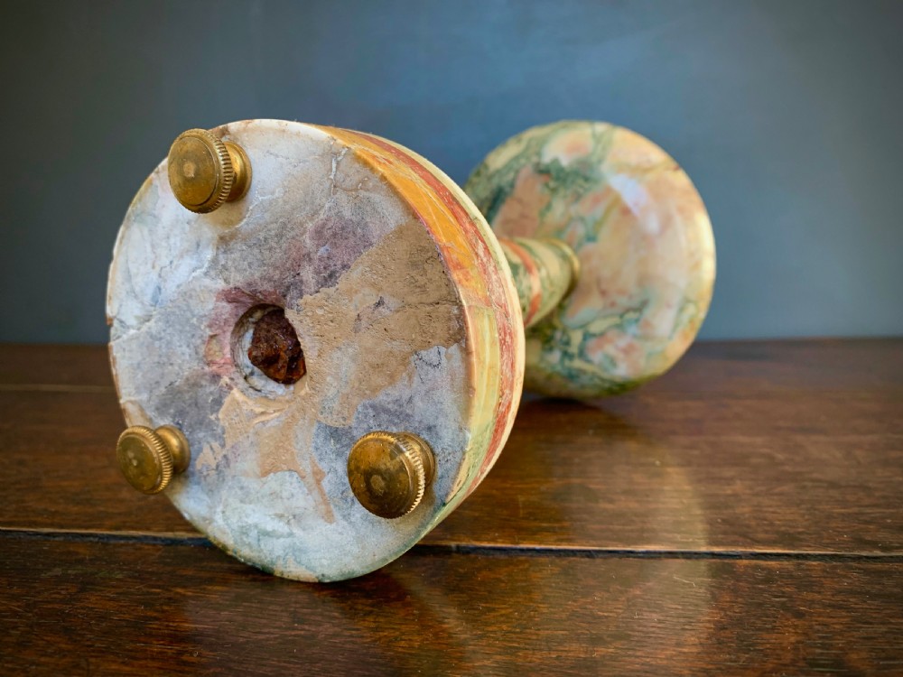 A pair of turned, variegated marble tazzas featuring shallow circular dishes raised on baluster stems and round bases in shades of red, green, and tan. View VIII