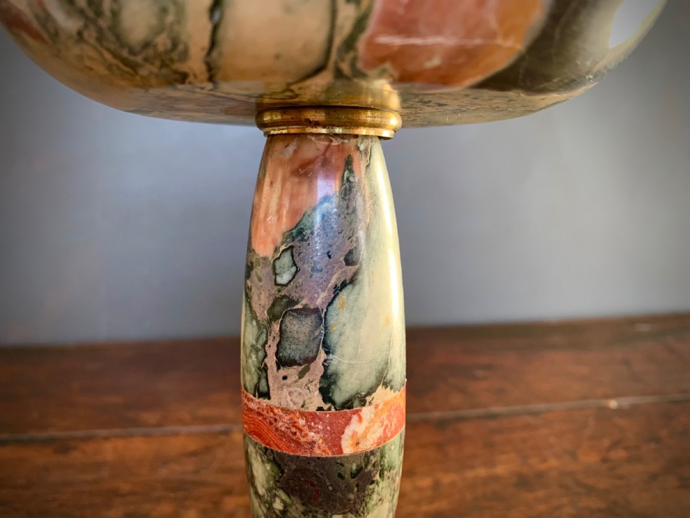 A pair of turned, variegated marble tazzas featuring shallow circular dishes raised on baluster stems and round bases in shades of red, green, and tan. View IX