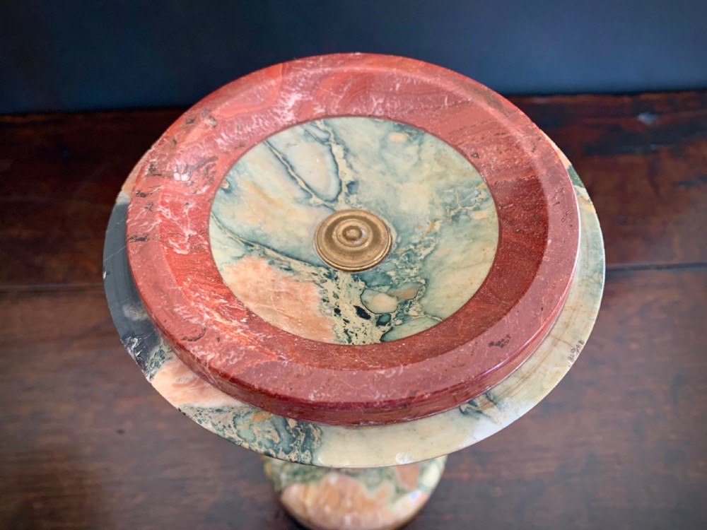 A pair of turned, variegated marble tazzas featuring shallow circular dishes raised on baluster stems and round bases in shades of red, green, and tan. View XI