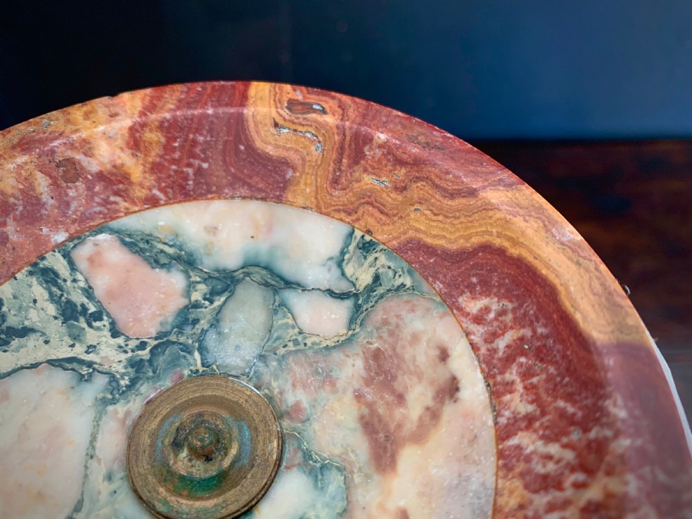 A pair of turned, variegated marble tazzas featuring shallow circular dishes raised on baluster stems and round bases in shades of red, green, and tan. View XII