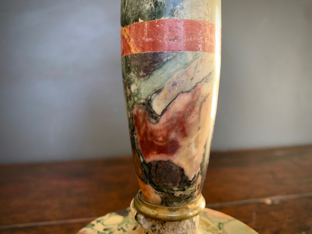 A pair of turned, variegated marble tazzas featuring shallow circular dishes raised on baluster stems and round bases in shades of red, green, and tan. View XV