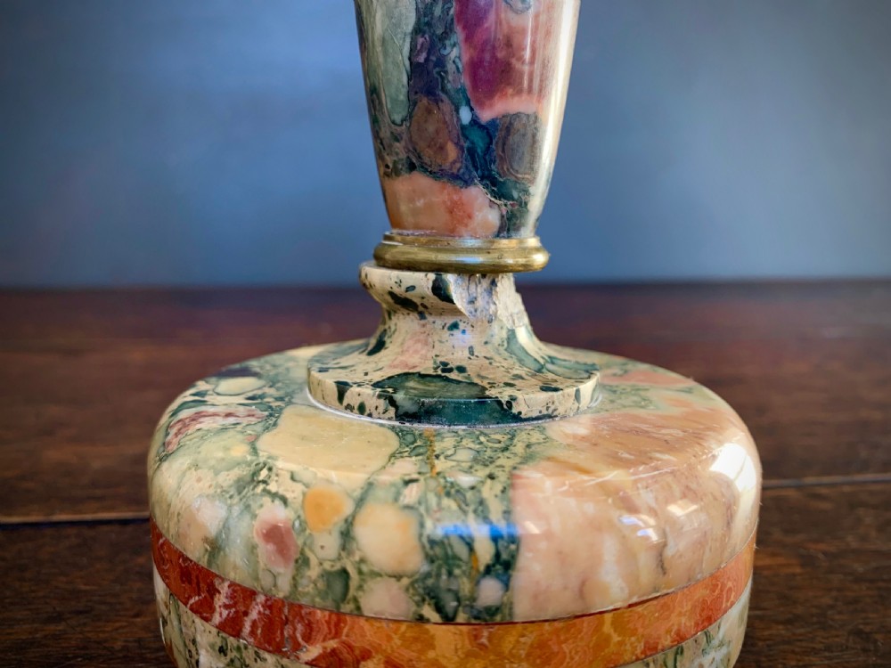 A pair of turned, variegated marble tazzas featuring shallow circular dishes raised on baluster stems and round bases in shades of red, green, and tan. View XVIII