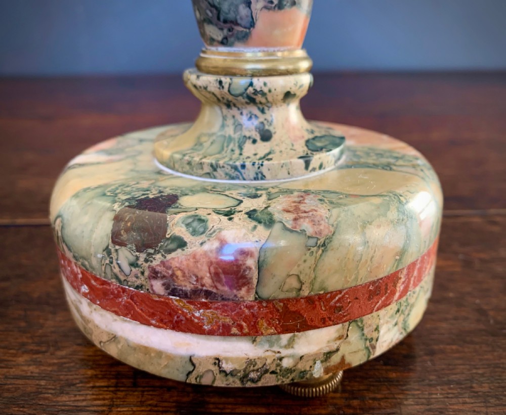 A pair of turned, variegated marble tazzas featuring shallow circular dishes raised on baluster stems and round bases in shades of red, green, and tan. View XXI