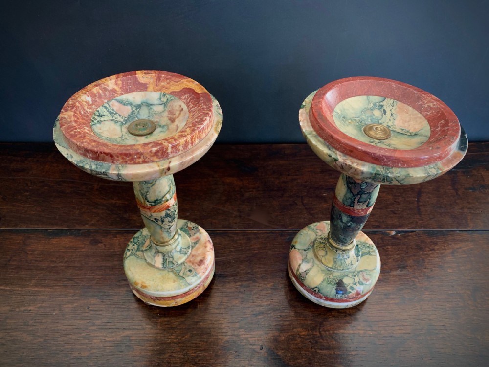 A pair of turned, variegated marble tazzas featuring shallow circular dishes raised on baluster stems and round bases in shades of red, green, and tan. View XXIII