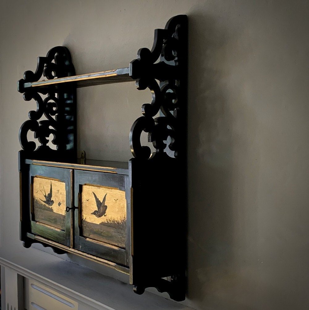 AESTHETIC MOVEMENT EBONISED WALL CABINET WITH GILDED PANELS PAINTED WITH BIRDS. View II