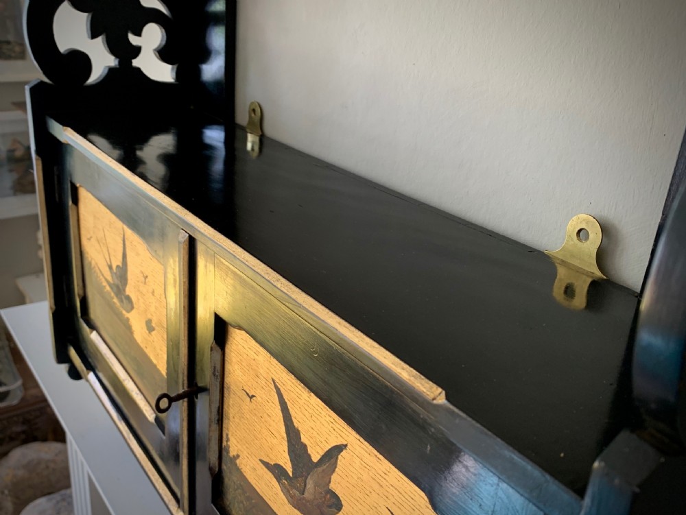 AESTHETIC MOVEMENT EBONISED WALL CABINET WITH GILDED PANELS PAINTED WITH BIRDS. View IX
