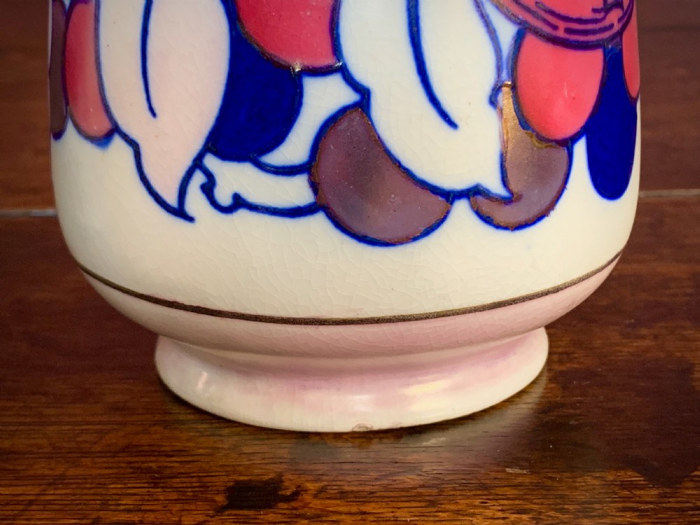 A pair of Art Deco earthenware vases featuring tubelined fruit motifs with iridescent lustre glazing on a cream background. View IX