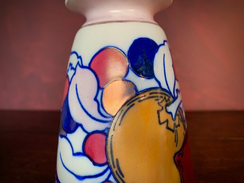 A pair of Art Deco earthenware vases featuring tubelined fruit motifs with iridescent lustre glazing on a cream background. View XI