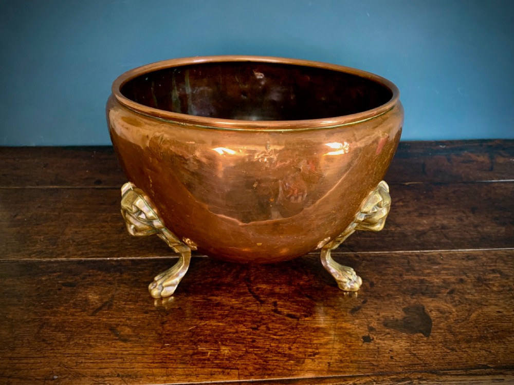 A rounded nineteenth-century copper jardiniere bowl supported on three cast brass lion mask paw feet. View III