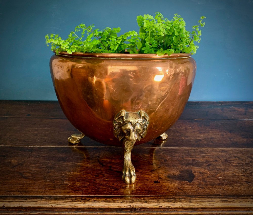 A rounded nineteenth-century copper jardiniere bowl supported on three cast brass lion mask paw feet. View VI