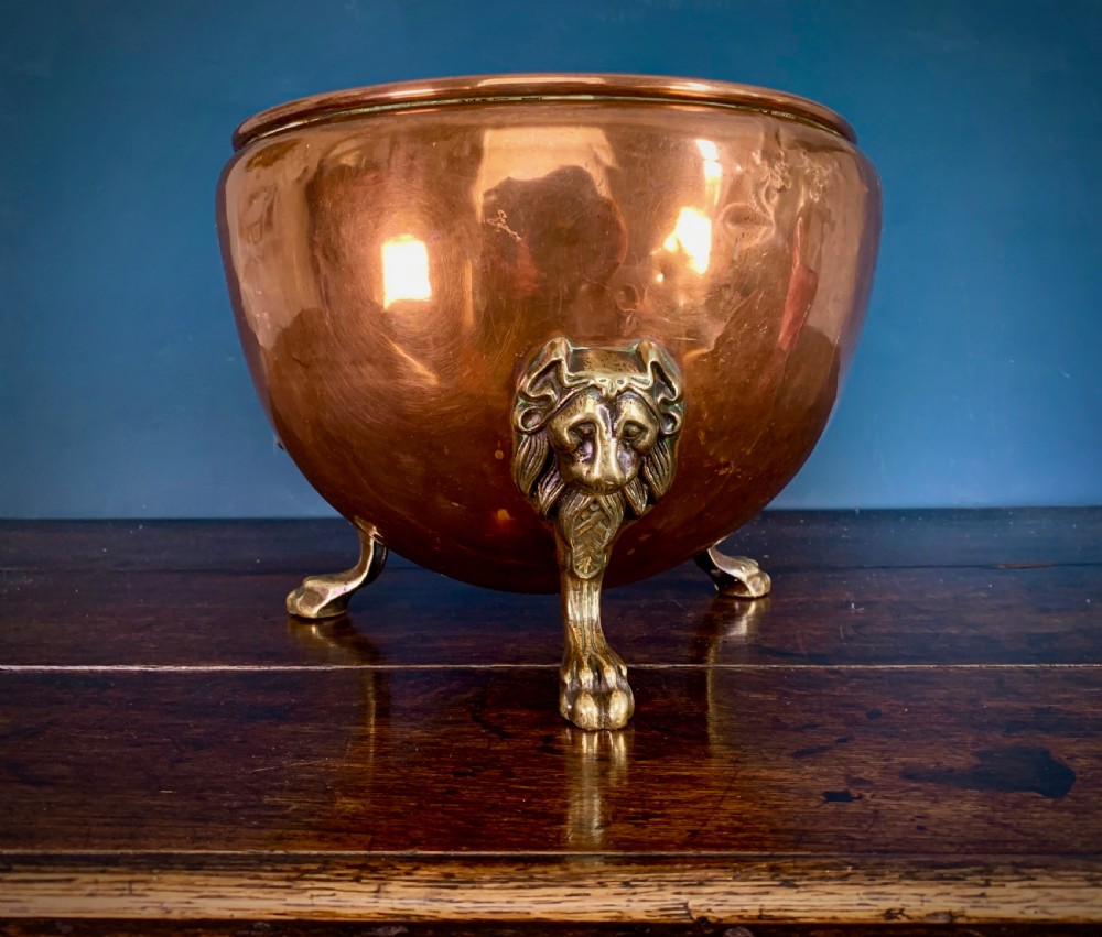 A rounded nineteenth-century copper jardiniere bowl supported on three cast brass lion mask paw feet. View VII