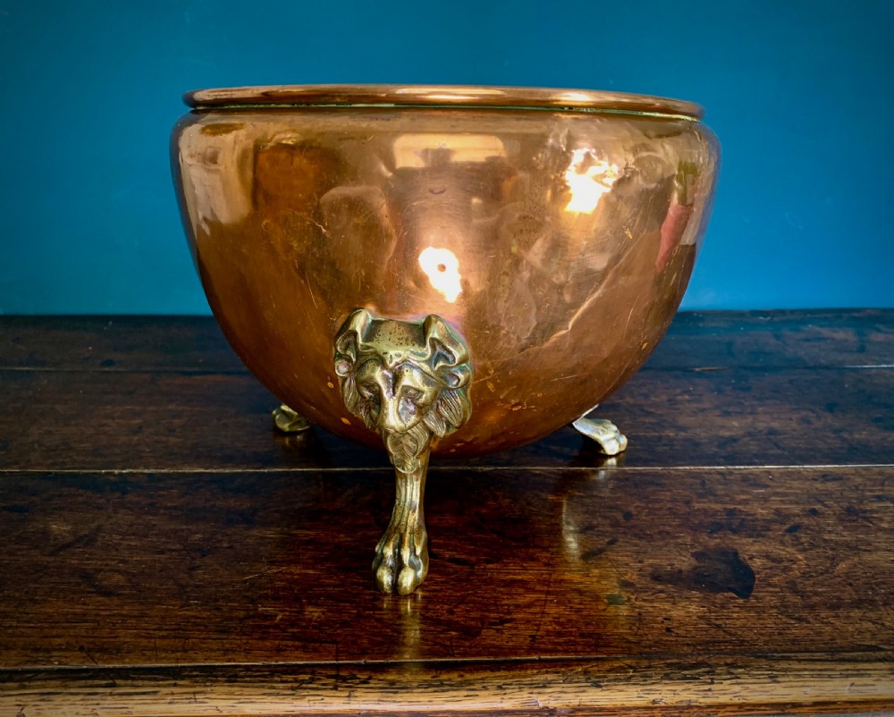 A rounded nineteenth-century copper jardiniere bowl supported on three cast brass lion mask paw feet. View VIII