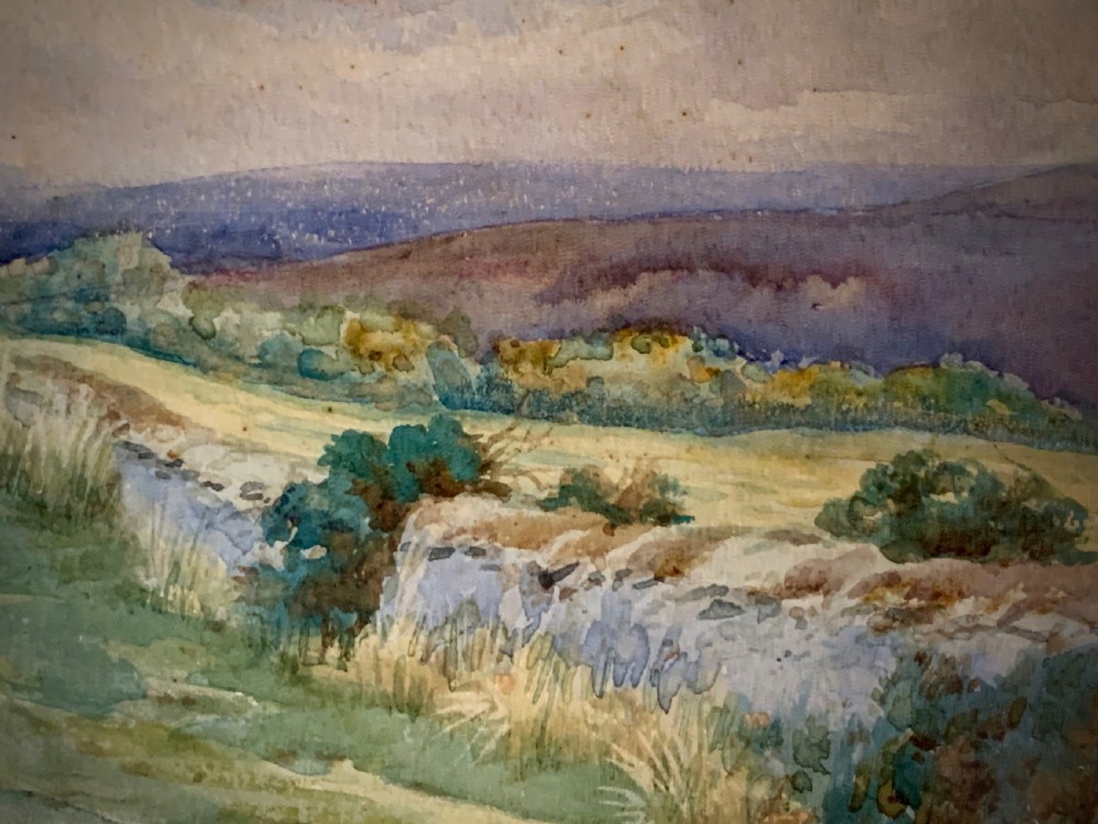 An antique framed watercolour painting depicting a shepherd driving sheep across a green moorland beneath a cloudy sky, set within a cream mount and gold frame. View IV