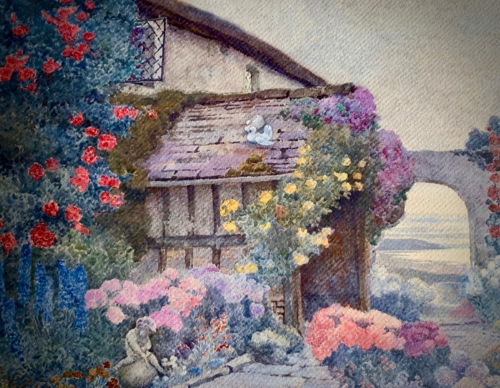 A framed 1928 watercolour painting depicting a stone path leading through a lush cottage garden towards a stone archway, presented in a wide gold frame. View II